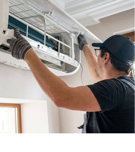 Plumber fixing pipes under a sink