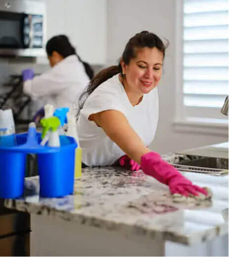 Cleaners deep cleaning a kitchen